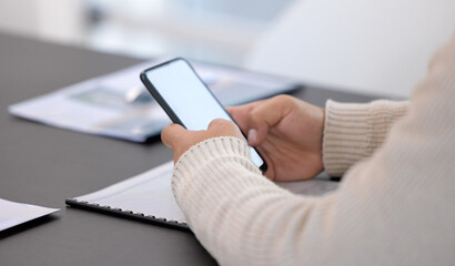 Fototapeta premium It helps to stay connected. Closeup shot of an unrecognisable businessman using a cellphone with a blank screen in an office.