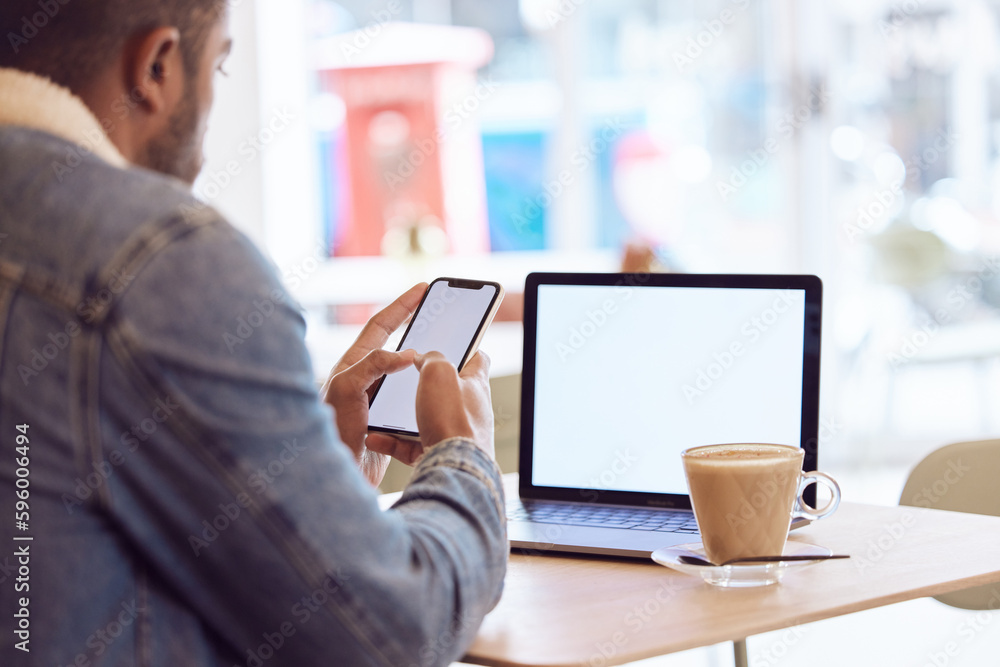Poster never going back to an office. a man using his smartphone and laptop to work in a coffee shop while 