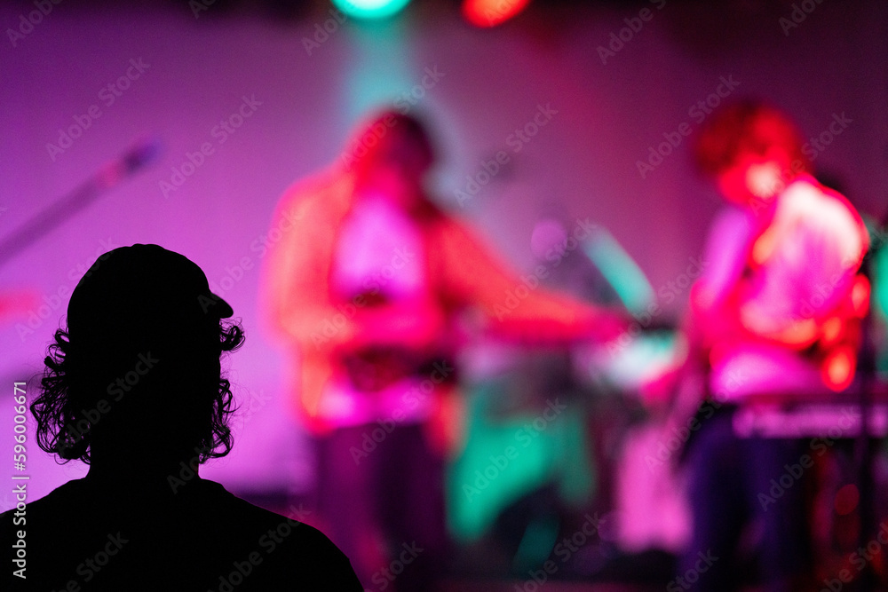 Wall mural band playing music and a gig in a venue, close up of a rock band playing guitars and instruments.