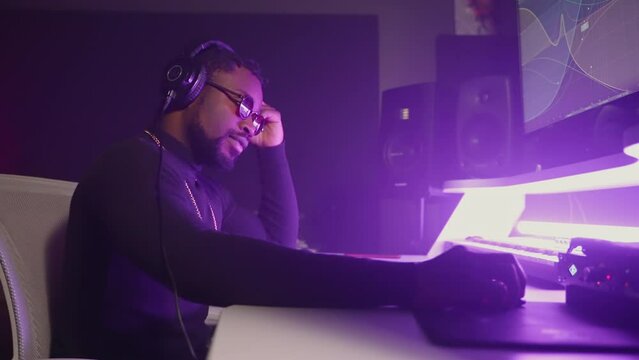 executive record producer or sound designer is working in professional recording studio