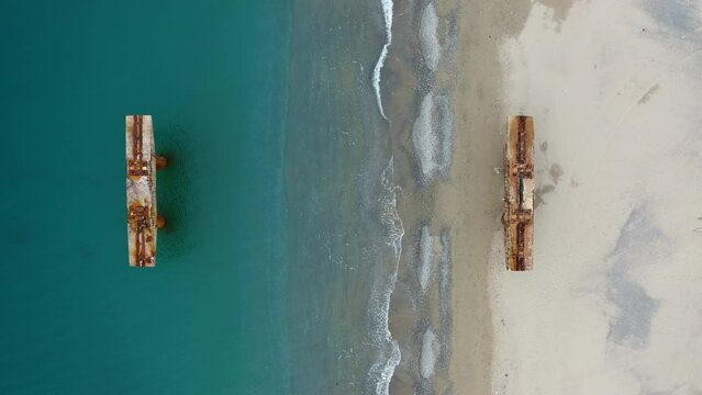 Abandoned and damaged industrial pier on the sea