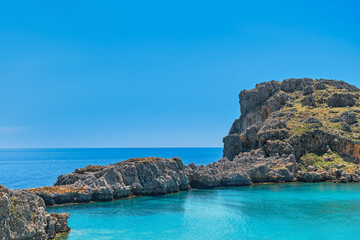 View from the beach of St. Paul's bay near the city of Lindos, clear blue sky and emerald sea,...