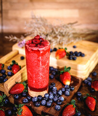 Healthy vitamin. Summer berries smoothie in mason jar on rustic wooden table