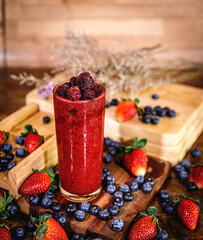Healthy vitamin. Summer berries smoothie in mason jar on rustic wooden table
