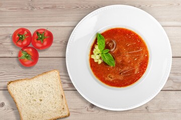 Bowl of hot tasty soup dish on the desk