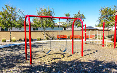 Fototapeta na wymiar Swing Set At Children's Neighborhood Park