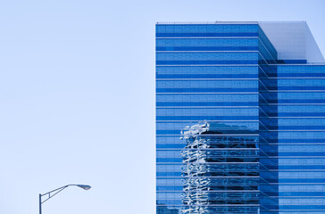 Business office building and street lamp against the blue clear sky