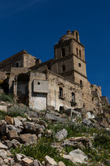 Fototapeta na wymiar Craco, Basilicata. Abandoned city. A ghost town built on a hill and abandoned due to geological problems. Surreal look, horror film scenery. Panorama of the Calanchi Park.