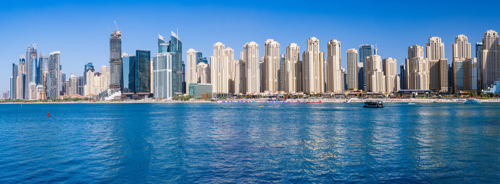 Wide panorama of new apartments among hotels on oceanfront in Jumeirah Beach Residence area of Dubai