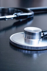 Medical stethoscope on a black table closeup
