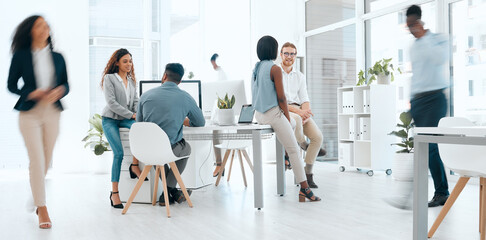 Keep up with the pace. a group of businesspeople working in a modern office at work.