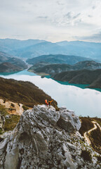 Family hiking outdoor travel people on cliff mountain aerial lake view active summer vacations healthy lifestyle eco tourism in Albania