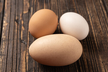 eggs on wooden table, A double-yolked chicken egg on a table