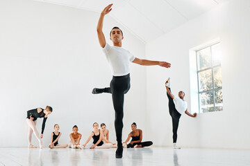 Expressing himself through dance. Full length shot of a diverse group of ballet students rehearsing in their dance studio.