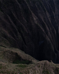 Aerial Na Pali Coast State Park on Kauai, Hawaii. High quality photo.  People hiking Awa'awapuhi Trail. Beautiful mountain backdrop of Hawaii's Na Pali Coastline with 1,000 foot steep cliffs. Sunset