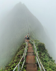 Man Hiking Stairway to Heaven (Haiku Stairs) on Oahu, Hawaii. High quality photo. Looking up the stairs.