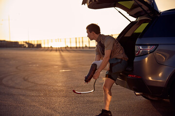 Young man preparing his prosthetic blade for a morning run