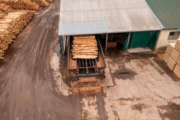 Fototapeta na wymiar Drone footage of sawmill, machinery and lumber during summer day.