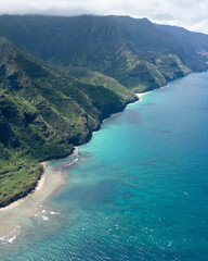 Aerial Na Pali Coast State Park on Kauai, Hawaii. High quality photo. Beautiful mountain backdrop of Hawaii's Na Pali Coastline with 1,000 foot steep cliffs. Shot on Sony A7iv from a helicopter.