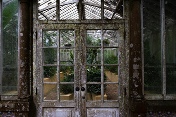 Front of an old, rusty and vintage looking greenhouse in Pena Park, Sintra, Portugal