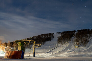 Nighttime with Starry Sky at the Ski Lift in Ramundberget Resort area in Sweden with empty Slopes...