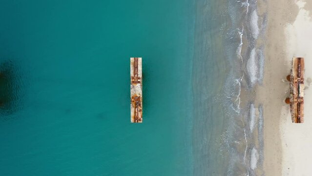 Abandoned and damaged industrial pier on the sea