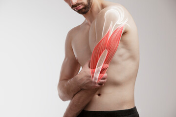Man holding a painfull arm, human arm pain