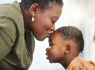Youre my angel on earth. a young mother kissing her daughter on her forehead.