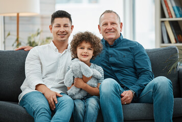 Two generations of strong men. a young man and his father spending time with his son.