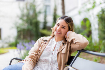 Fototapeta premium happy smiling young woman on summer city street