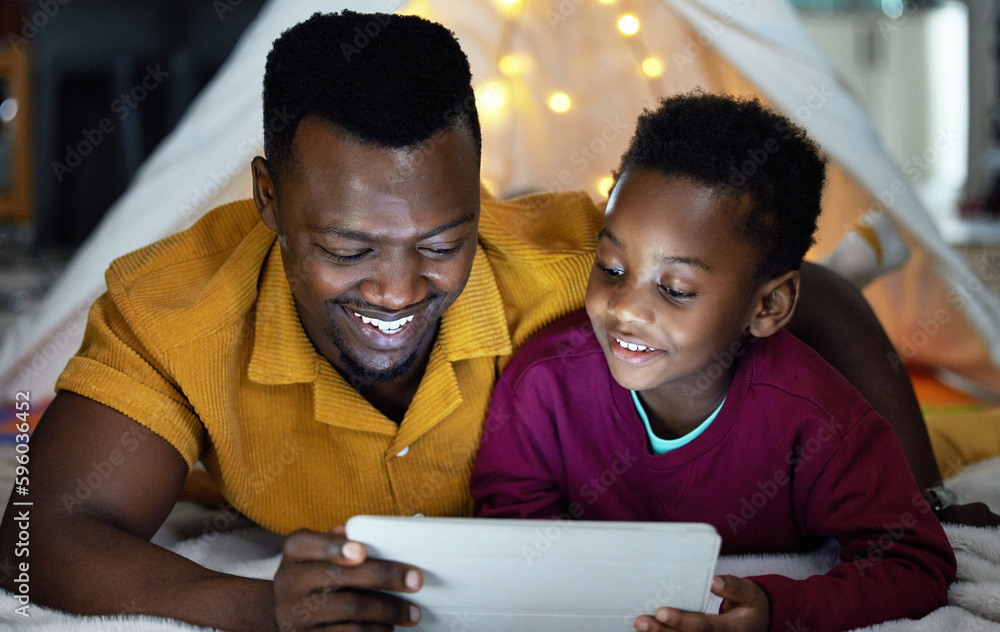 Poster Browsing educational sites from morning til night. an adorable little boy using a digital tablet with his father during bedtime at home.