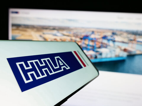 Stuttgart, Germany - 04-20-2023: Cellphone with logo of company Hamburger Hafen und Logistik AG (HHLA) on screen in front of website. Focus on center-left of phone display.
