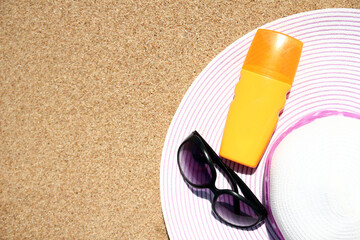 Stylish beautiful hat with cream on the seashore background