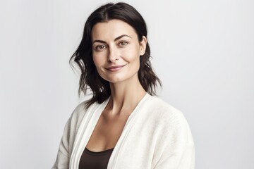 Obraz premium Medium shot portrait photography of a pleased woman in her 30s wearing a chic cardigan against a white background. Generative AI