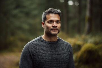 Fototapeta premium Portrait of a handsome young man in the forest. Men's beauty, fashion.