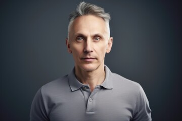 Obraz premium Portrait of a handsome middle-aged man in a gray t-shirt
