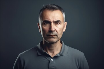 Fototapeta premium Portrait of a mature man on dark background. Toned.