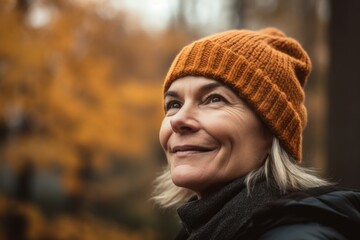 Portrait of a happy senior woman in the autumn park. Soft focus.