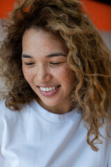 Attractive curly woman with freckles.