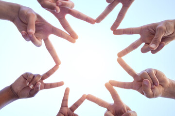 Spreading love and peace. a group of people forming star shapes with their hands in a circular...