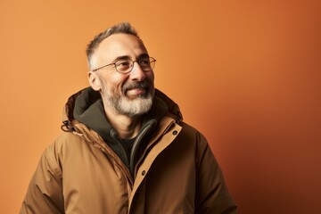 Obraz premium Portrait of a handsome senior man wearing a coat and glasses.