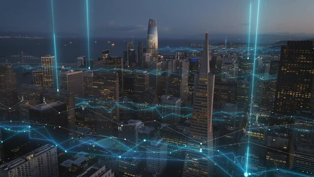 Aerial slide and pan footage of modern downtown skyscrapers at dusk. Computer added graphics, visual effects. San Francisco, USA