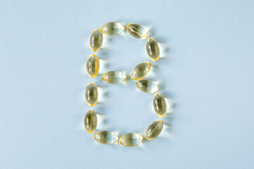 The transparent capsules are shaped like the letter B on a blue background.