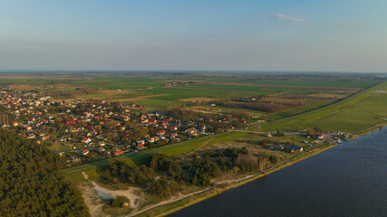 Fototapeta na wymiar Mikoszewo. Drone view of the city and the Vistula River on a sunny afternoon in early spring.