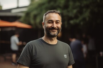 Obraz premium Portrait of a handsome bearded man in a black t-shirt.