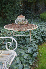 Beautiful old garden furniture with decoration in an idyllic garden.