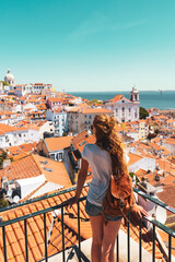 Traveler Woman, tourist on balcony looking at panoramic view of Lisboa- Tourism, vacation, travel in Portugal - obrazy, fototapety, plakaty