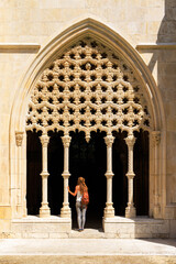 Monastery of Batalha-woman tourist visiting royal cloister- Portugal- April 2023
