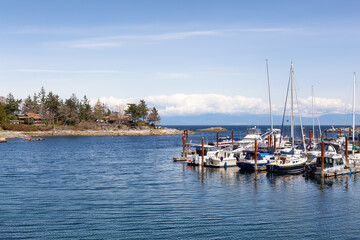 Fototapeta na wymiar Sailboats in marina on the ocean shore. Nanoose Bay, Vancouver Island, British Columbia, Canada.