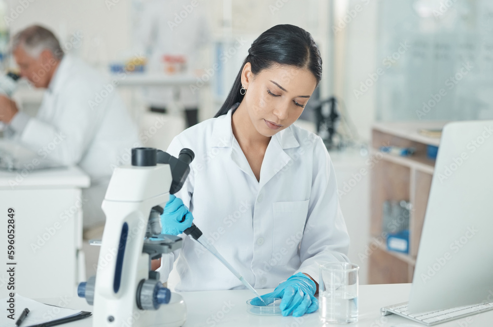 Poster A good lab technician is meticulous and cautious. a young scientist working with samples in a lab.